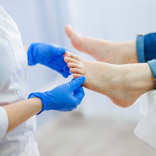 Podiatry doctor examines the foot