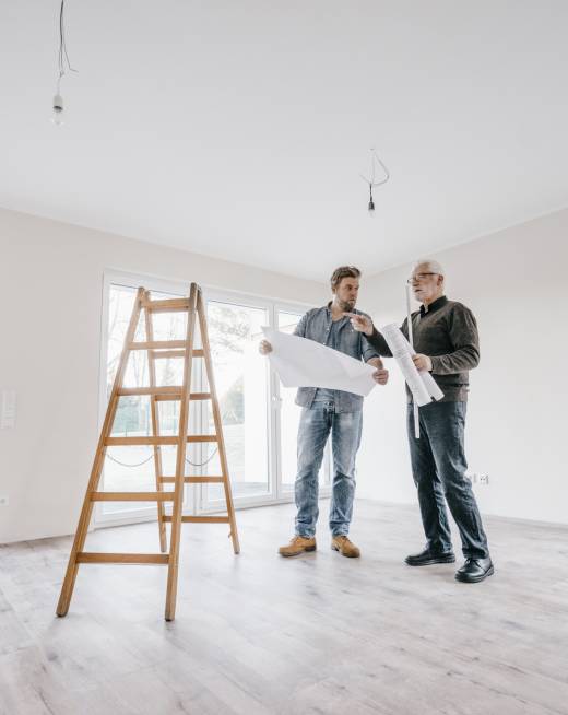 Architect checking construction plan with owner of the new home